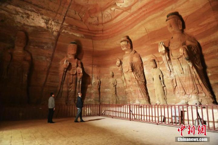 7月15日，游人參觀甘肅省平?jīng)鍪袥艽h百里石窟長廊中的南石窟寺1號窟。百里石窟長廊位于涇川縣境內(nèi)，由512個石窟、5眼窟中石井組成，現(xiàn)存王母宮石窟、鳳凰山石窟、南石窟寺、丈八寺石窟、羅漢洞石窟、太山寺石窟等規(guī)模較大的石窟群，還有數(shù)量眾多的小石窟群。南石窟寺開鑿于北魏永平三年，其中1號窟屬于大型七佛窟，七佛高達(dá)6米。中新社記者 李亞龍 攝